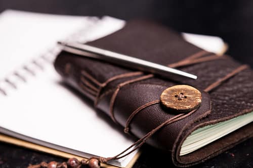 Leather covered vintage ntoebook on an open diary